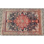 A GOOD MALAYER RUG, red ground with stylised floral decoration within, a pale blue border. 6ft 10ins