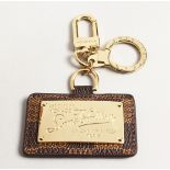 A LOUIS VITTON PATTERN KEY RING in a box.