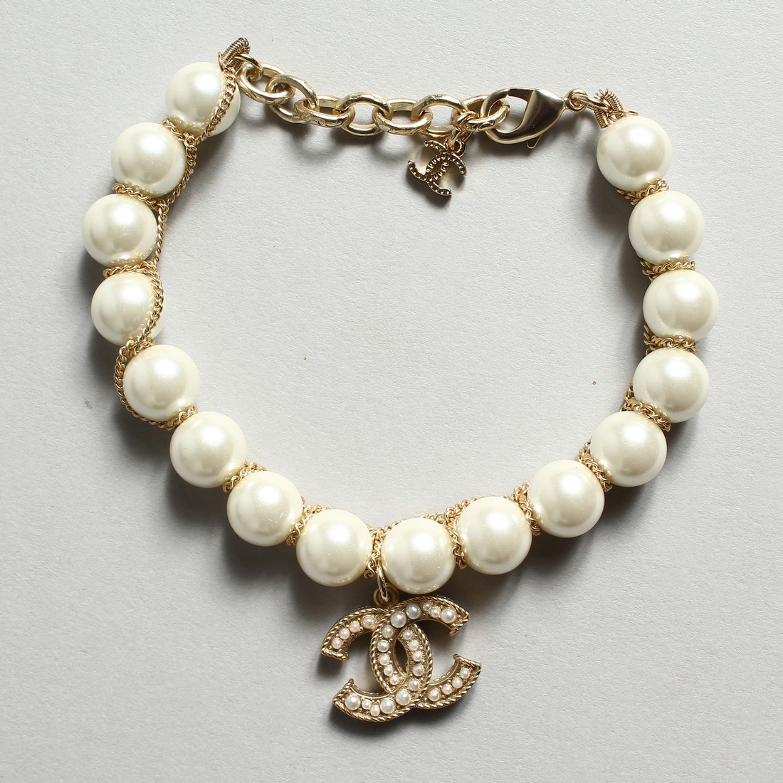 A CHANEL STYLE PEARL AND ENTWINED C BRACELET in a Chanel box