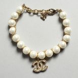 A CHANEL STYLE PEARL AND ENTWINED C BRACELET in a Chanel box