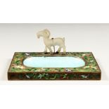 AN ENAMEL DECORATED ASH/PIN TRAY with a jade deer. 5.75ins long, 3.75ins deep.