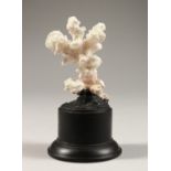 A CORAL SPECIMAN on a plinth. 2.5ins high.