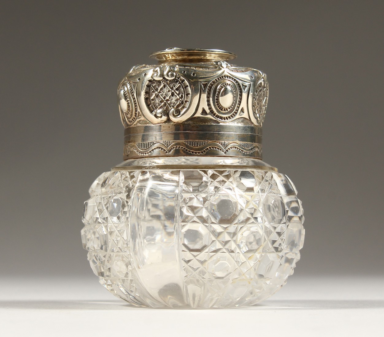 A CUT GLASS CIRCULAR SCENT BOTTLE AND COVER London 1896