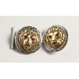 A PAIR OF SILVER AND GOLD PLATED LION HEAD CUFF LINKS