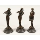 A SET OF THREE ART NOUVEAU BRONZE FEMALE MUSICIANS on a circular base. 7.5ins high