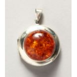 A SILVER AND AMBER LOCKET