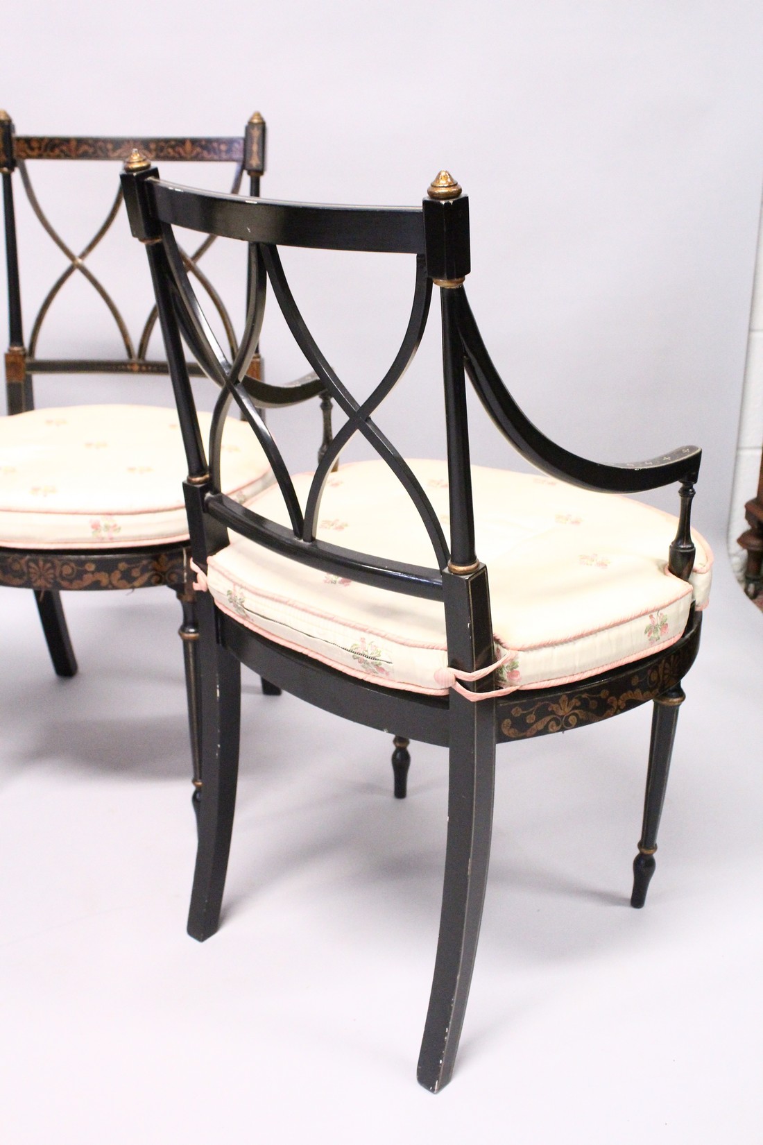 A SET OF FOUR BLACK AND GILT CHAIRS, two with arms, with cross fret backs and cane seats. - Image 4 of 4