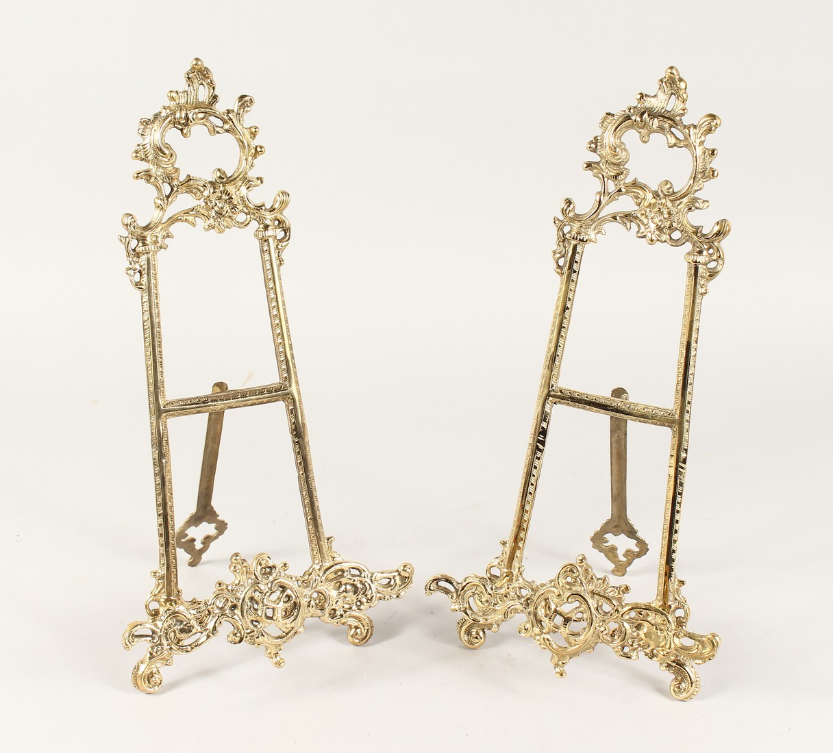 A PAIR OF MEDIUM BRASS EASELS 1ft 4ins high