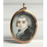 A GEORGIAN OVAL MINIATURE OF A YOUNG MAN, the reverse with plated hair. 1.25ins x1.25ins