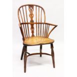 AN 18TH CENTURY YEW WOOD WINDSOR ARMCHAIR with crinoline stretcher.