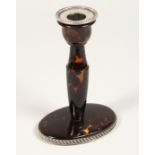 A TORTOISESHELL SILVER MOUNTED CANDLESTICK 5ins high.