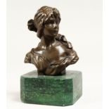A SMALL FEMALE BUST 4.5ins high on a marble base.