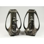 A LARGE PAIR OF ART NOUVEAU PEWTER TWO HANDLED VASES, the sides with classical female figures in