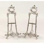 A PAIR OF MEDIUM SILVERED EASELS 1ft 4ins high