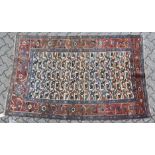A GOOD PERSIAN RUG, the central beige ground with all over stylised animal motifs. 7ft 8ins x 4ft