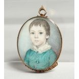A GEORGIAN OVAL MINIATURE OF A YOUNG BOY, young boys in a gilt frame. 1.25ins x1ins