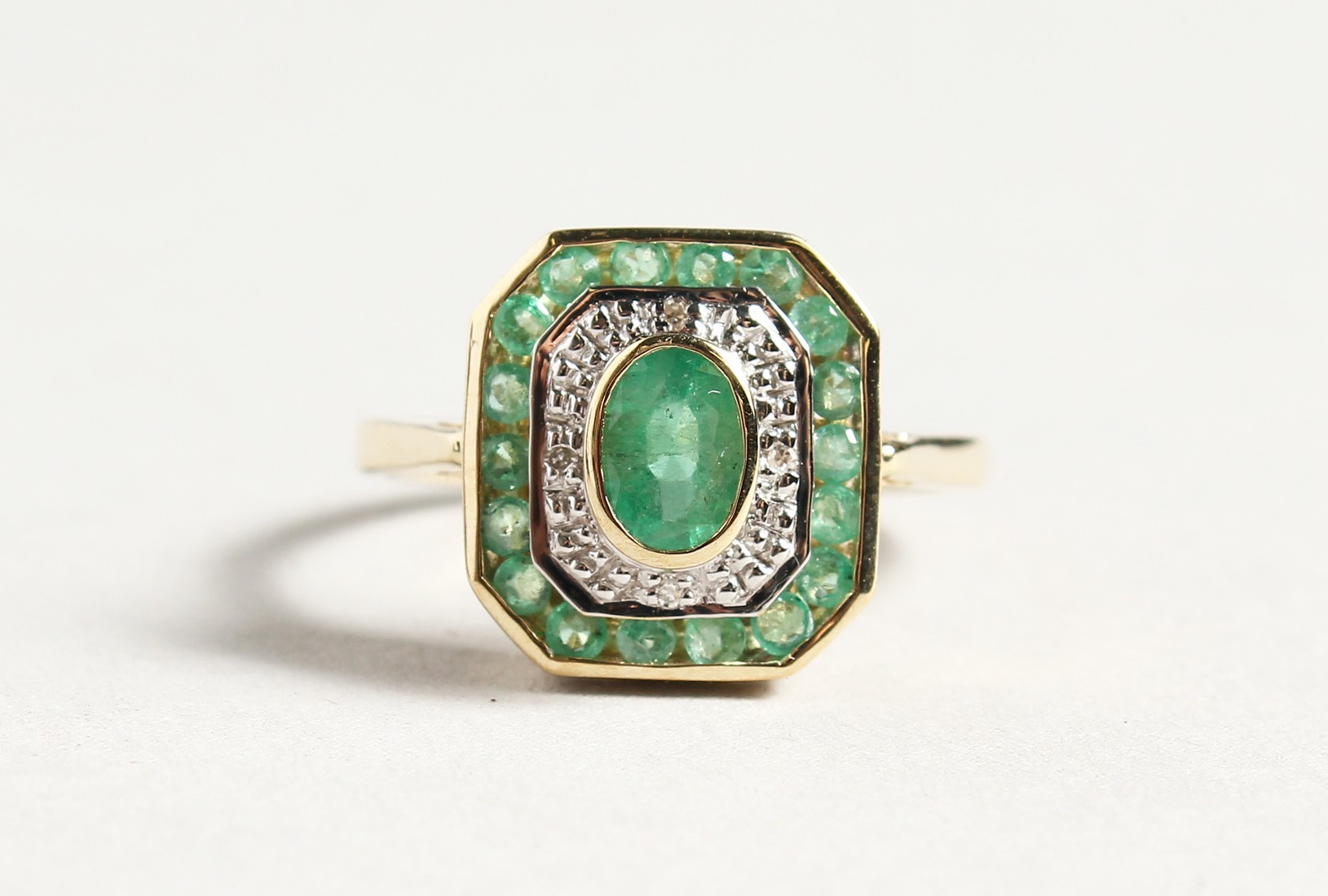 A 9CT GOLD EMERALD AND DIAMOND DECO STYLE RING