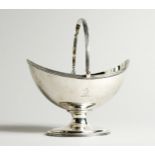 A GEORGE III SILVER BOAT SHAPED SUGAR BASKET with reeded swing handle, crested. London 1809,