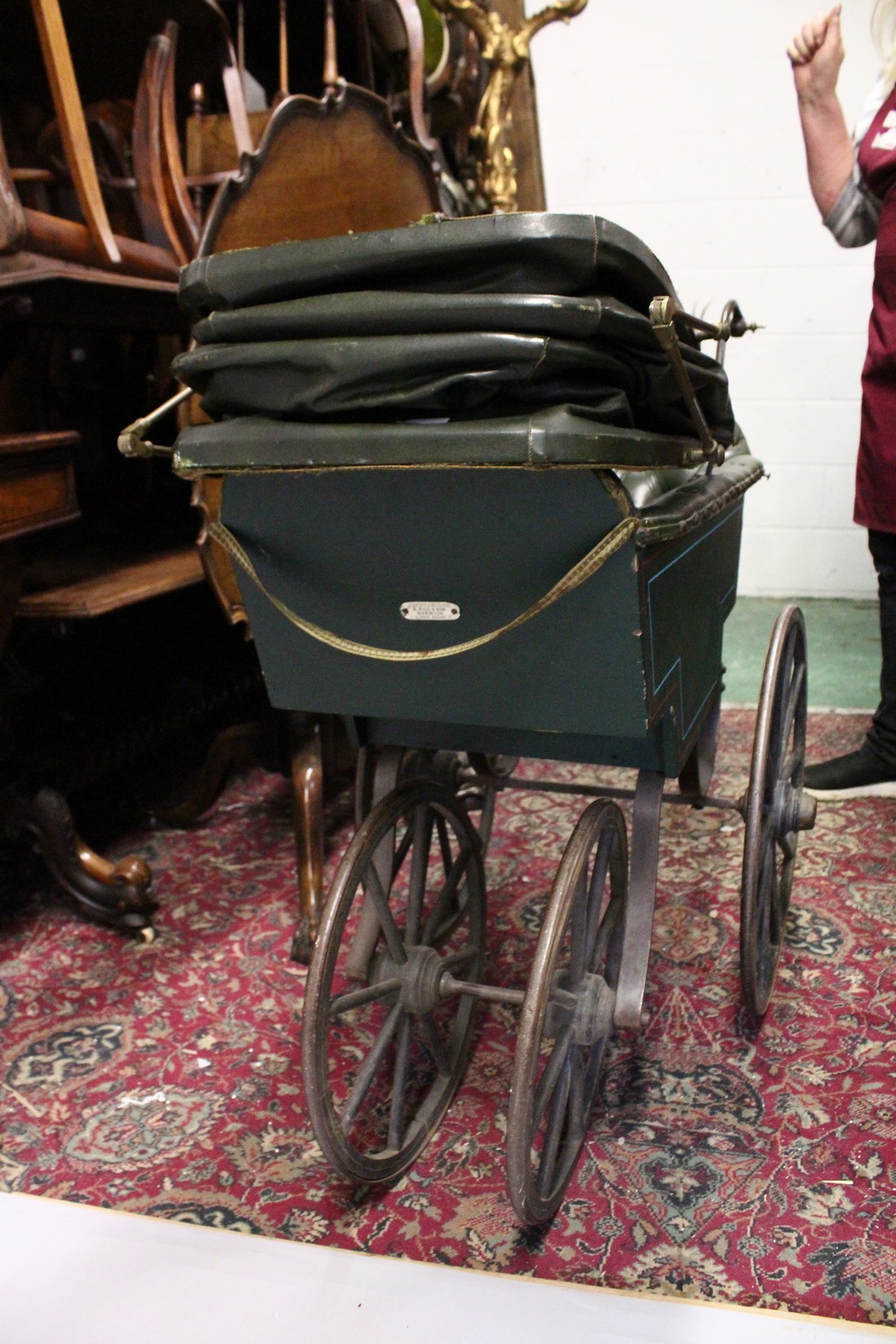 A RARE VICTORIAN METAL, WOOD AND LEATHER PRAM with folding hood, porcelain handles, wooden wheels. - Image 7 of 7