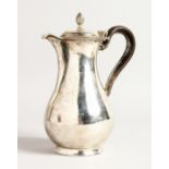 A VICTORIAN SILVER HOT WATER JUG with leather handle. Sheffield 1877, maker C.F. Weighs 13ozs.