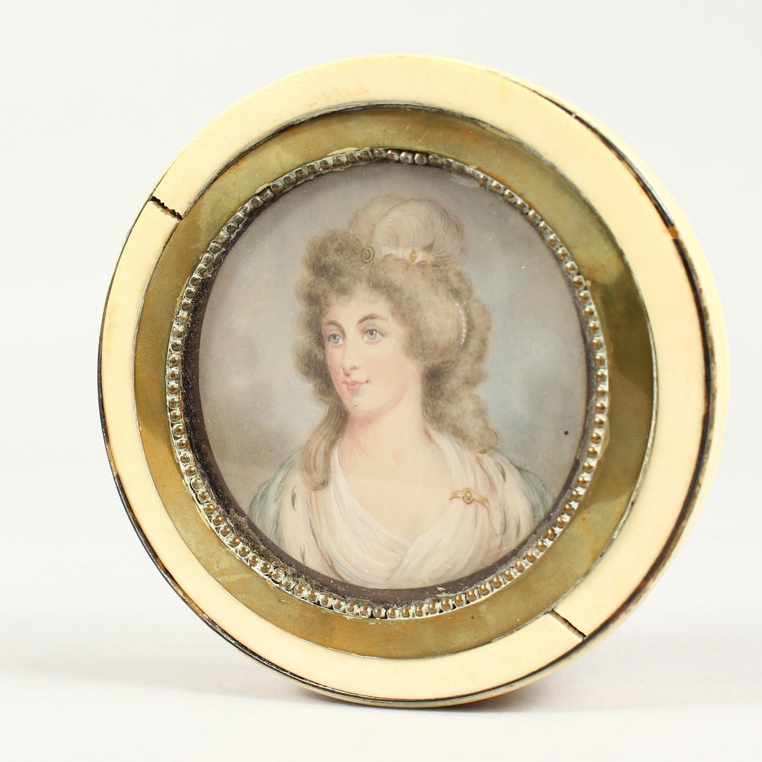 A GEORGIAN IVORY CIRCULAR BOX, the top painted with a portrait of Lady Mary Onslow. 3.75ins