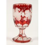A GOOD BOHEMIAN RUBY GLASS GOBLET ethched with fruiting vines on an octagonal base. 6ins high.