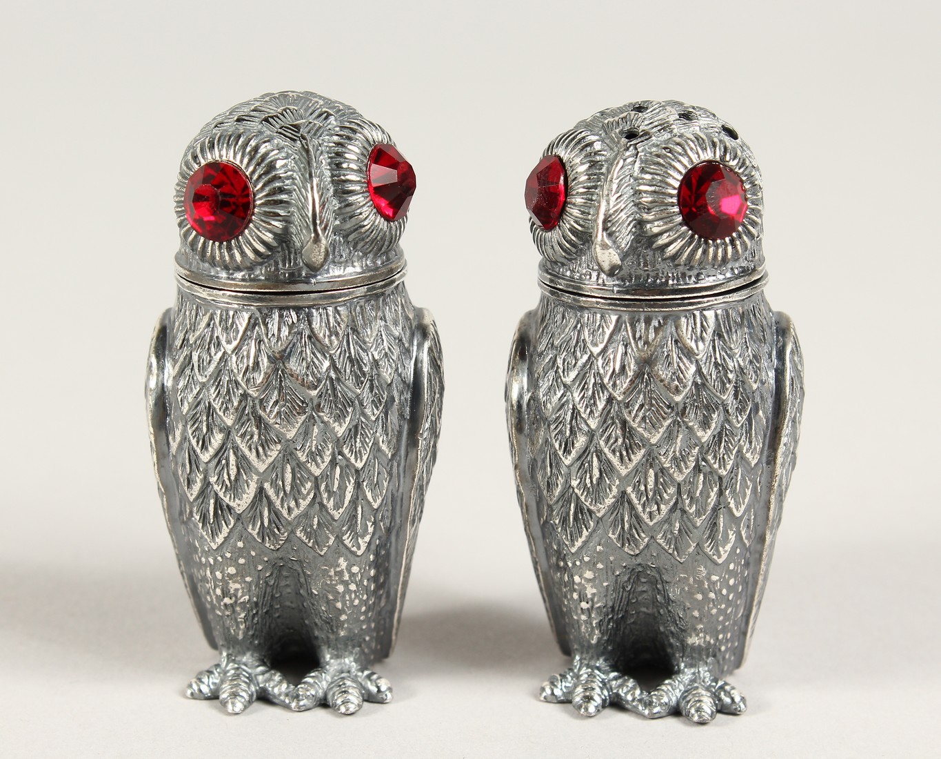 A PAIR OF SILVER PLATE OWL SALT AND PEPPERS