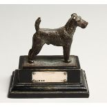 A FOX TERRIER with silver tablet. 2.5ins long