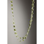 A SILVER FACET CUT PERIDOT LONG CHAIN