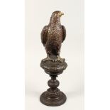 A GOOD BRONZE EAGLE on a pedestal. 16ins high.