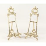 A PAIR OF LARGE BRASS EASELS 1ft 8ins high.