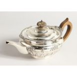 A VICTORIAN CIRCULAR SILVER TEA POT with gadrooned edge and repousse decoration. London 1896,