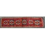 A LONG PERSIAN RUNNER with six main medallions 14ft long x 3ft 3ins wide