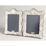 A PAIR OF SILVER REPOUSSE PHOTOGRAPH FRAMES 7.5ins x 5.5ins