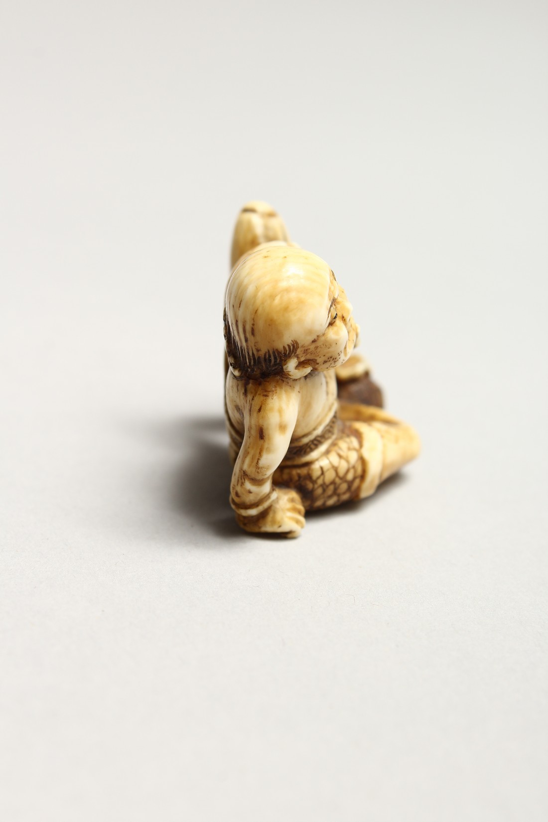 A CARVED BONE NETSUKE OF AN ONI 1.5ins - Image 2 of 6