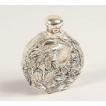 A .8OO WHITE METAL CIRCULAR SCENT BOTTLE, a classical lady with doves. 2ins diameter