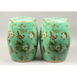 A PAIR OF CHINESE GREEN FLORAL DECORATED SEATS 18ins high.