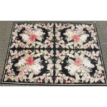 A LARGE ABUSSON STYLE TAPESTRY WALL HANGING, black ground, with floral decoration. 14ft 2ins x