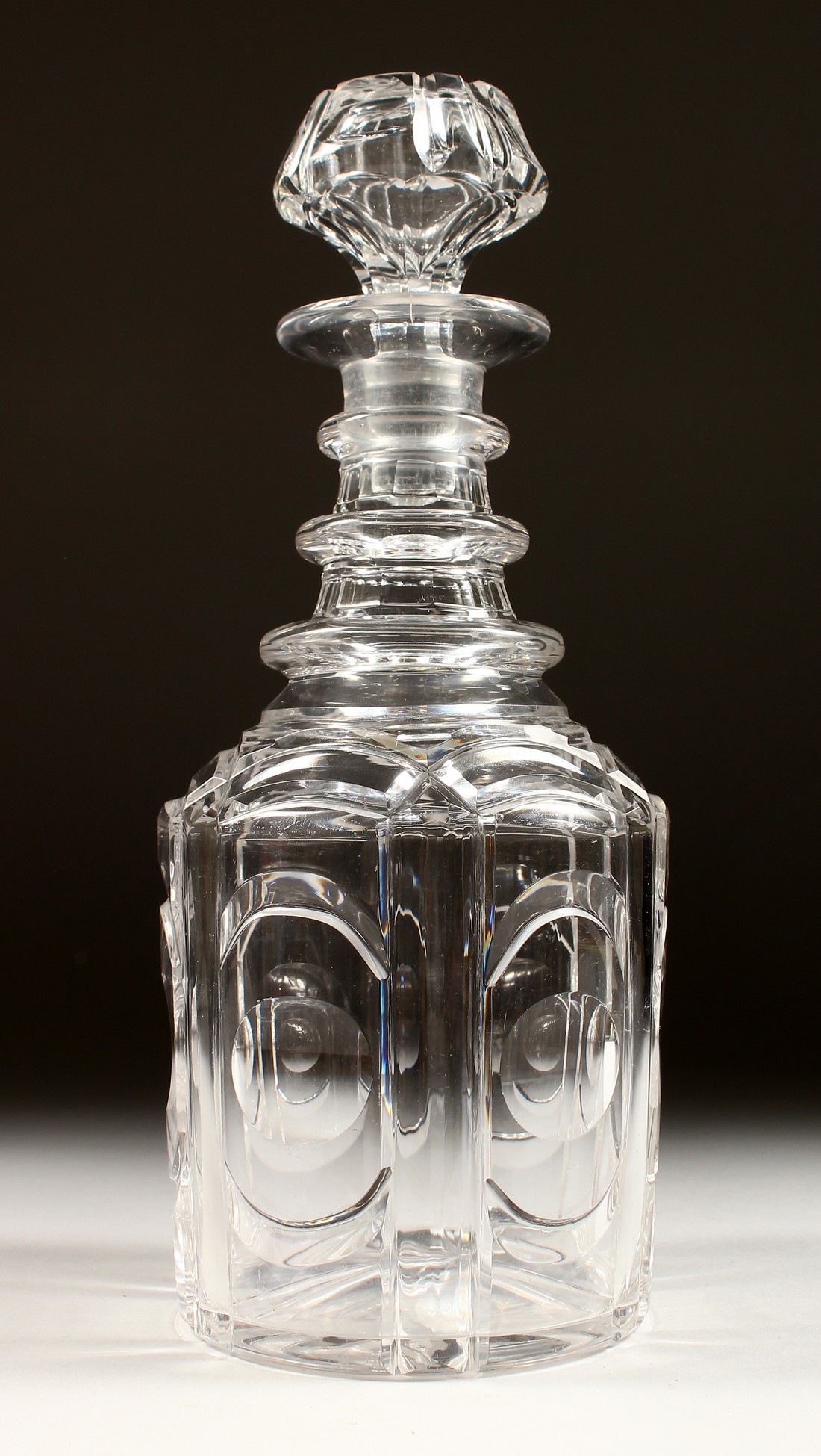 A HEXAGONAL CUT GLASS DECANTER AND STOPPER