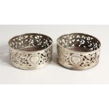 A GOOD PAIR OF GEORGE III IRISH SILVER WINE COASTERS with plain wooden bases, the silver sides