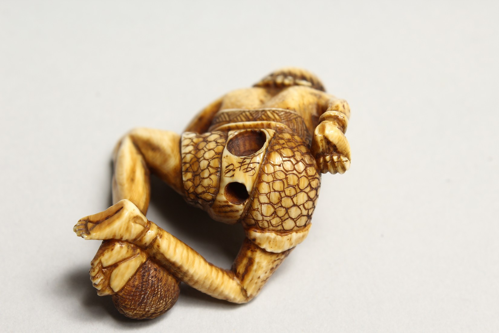 A CARVED BONE NETSUKE OF AN ONI 1.5ins - Image 6 of 6