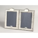 A PAIR OF SILVER BEAD EDGE PHOTOGRAPH FRAMES. 7.5ins x 5ins