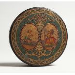 A GEORGIAN PAPIER MACHE CIRCULAR BOX, the top painted with two musicians. 3ins diameter.