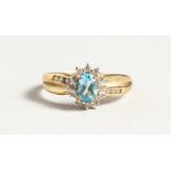A 9CT GOLD BLUE TOPAZ AND DIAMOND CLUSTER RING