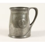 A TUDRIC ARCHIBALD KNOX PEWTER TANKARD with an oval of a golfer No. 066 4.25ins high.