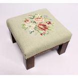 A SQUARE STOOL with needlework top. 11ins high