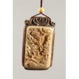 A CHINESE CARVED BONE AND WOOD PENDANT