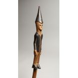 A SOUTH AFRICAN WOODEN STAFF with elongated figures 39ins long
