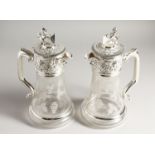 A PAIR OF CLARET JUGS engraved with fruiting vines, with plated mounts