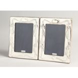 A PAIR OF SILVER ART NOUVEAU DESING PHOTOGRAPH FRAMES 7.5ins x 5.5ins